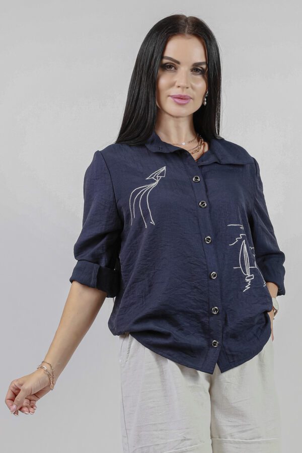 woman wearing cotton chirt blue color with embroidered details