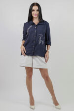 woman wearing blue cotton shirt with embroidery and linen shorts