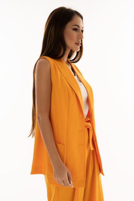 Woman wearing orange waistcoat with pockets