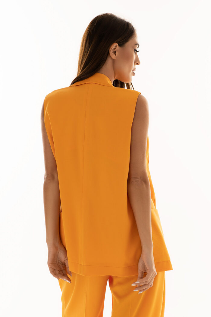 Woman Wearing Orange Waistcoat With Pockets