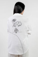 woman wearing linen shirt with embroidery
