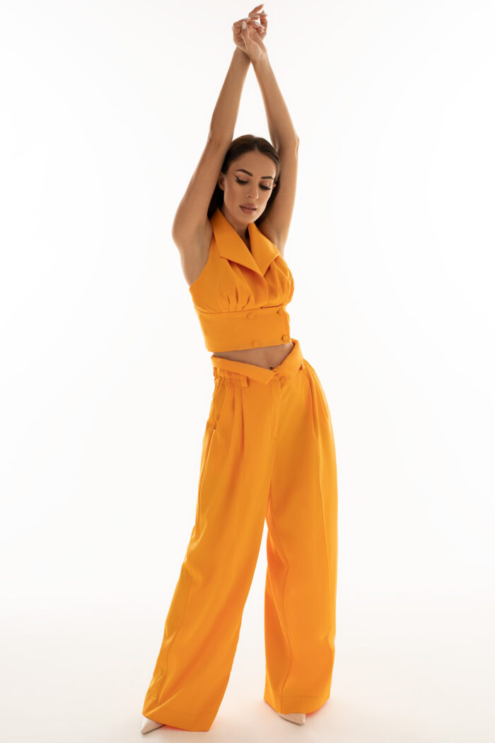 Woman Wearing Orange Cropped Top With Buttons
