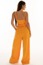 woman wearing orange cropped top with buttons