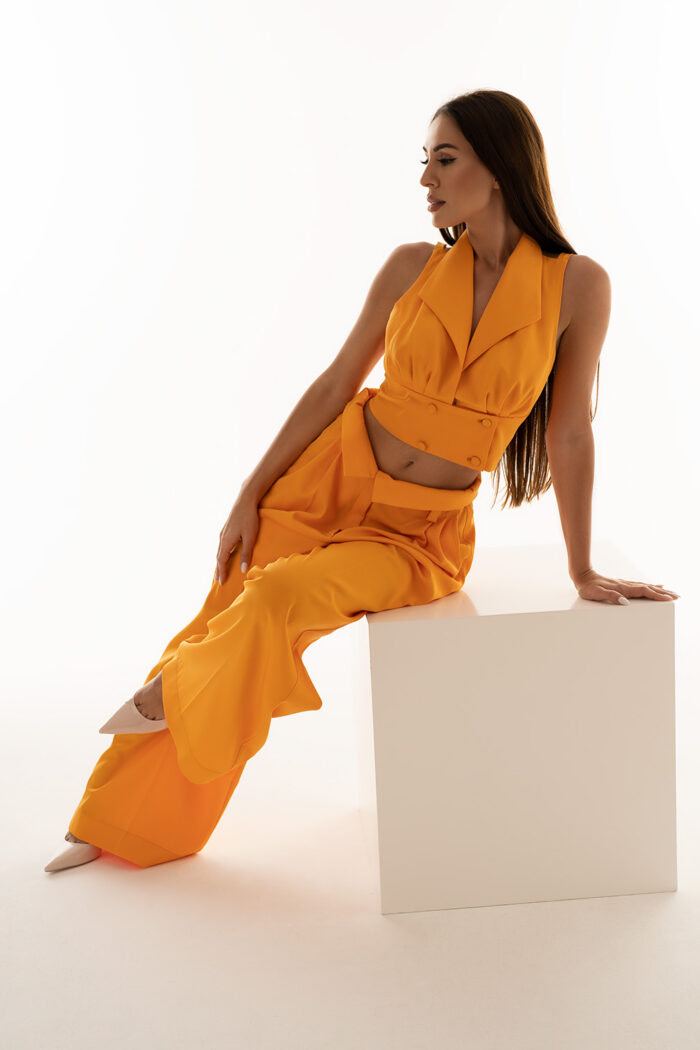 Woman Wearing Orange Cropped Top With Buttons