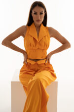 woman wearing orange cropped top with buttons