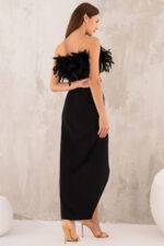 woman wearing black skirt and top with feathers