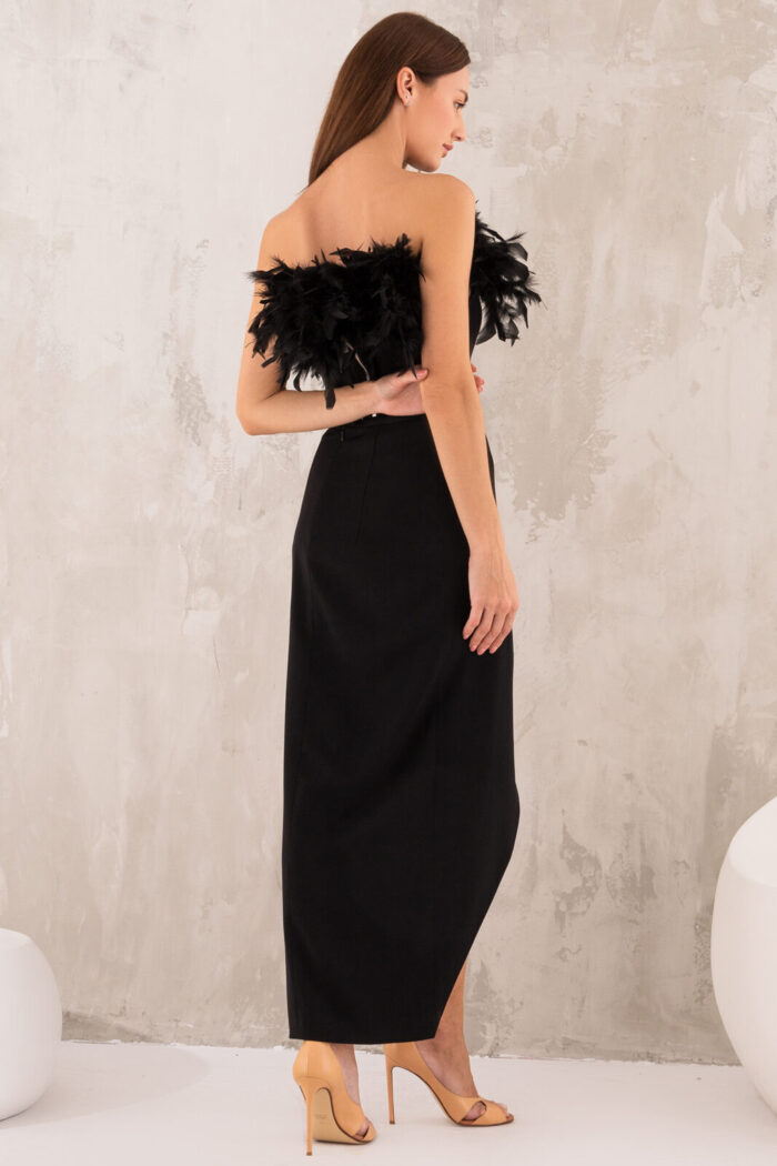 Woman Wearing Black Skirt And Top With Feathers