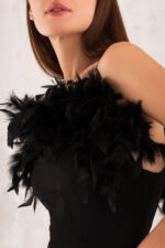 woman wearing black top with feathers