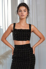 woman wearing tweed cropped top black and golden color