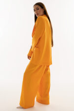 woman wearing oversized blazer and high-waisted trousers orange color
