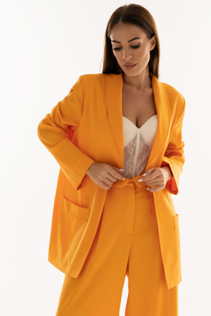 Woman Wearing Oversized Blazer And High-Waisted Trousers Orange Color