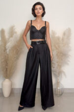 woman wearing wide-leg faux leather trousers and cropped top